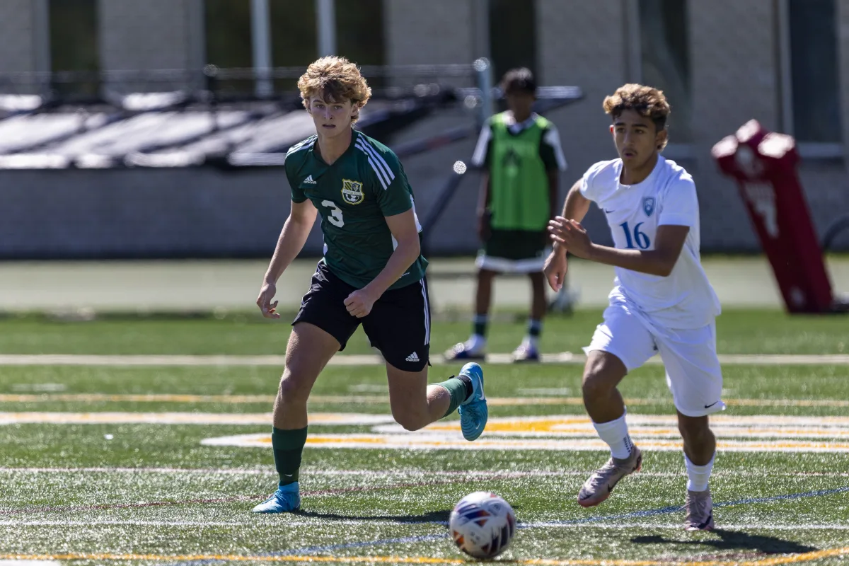 Cole Dirks ’26 chases for the ball against Vernon Hills. The Patriots managed to keep the ball away from their side for 20 straight minutes in the second half, dominating on offense.
