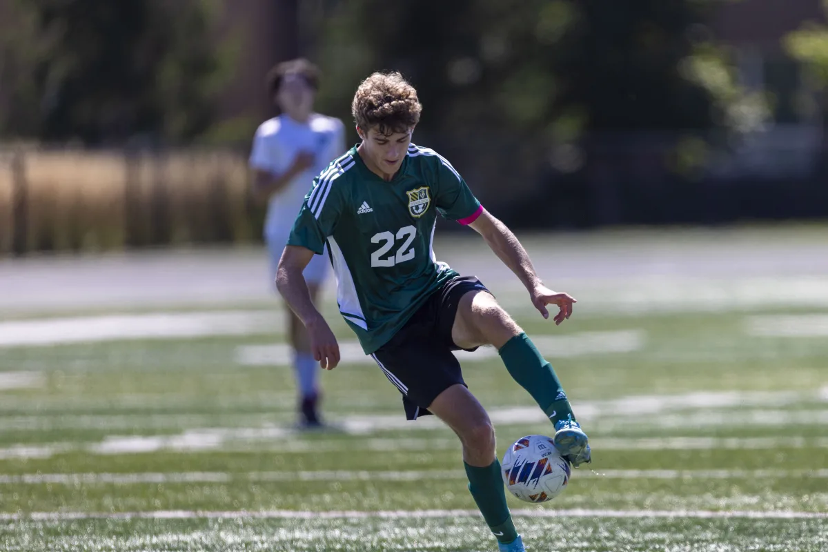 Jack Bacher ’25 juggles the ball to hold possession for the Patriots. Bacher finished with 2 goals on the day, both in the first half.
