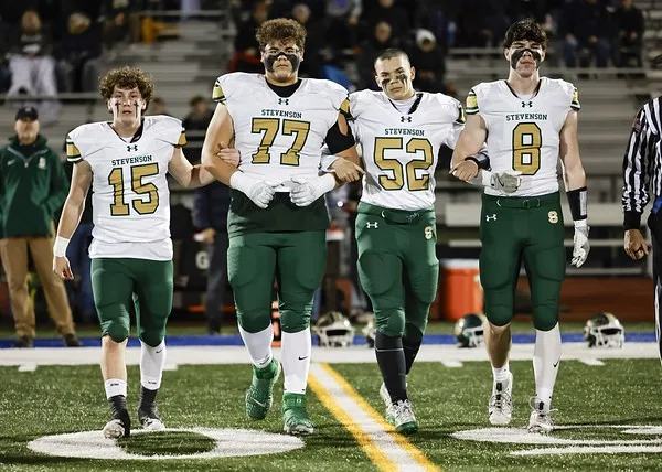 Team captains Aidan Crawley ’26, Albert Murillo ’25, Luke Nelson ’25, and Griffin Suren ’25 take the field arm and arm for the coin toss. As captains, they’ve led the Patriots team to a strong 10 wins on the season.