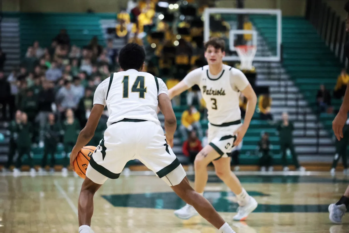 Stevenson forward Atticus Richmond '25 moves into position to receive the ball from guard Donovan Williams '26. Richmond ended the night with numerous points on the board, helping the Patriots stay up.