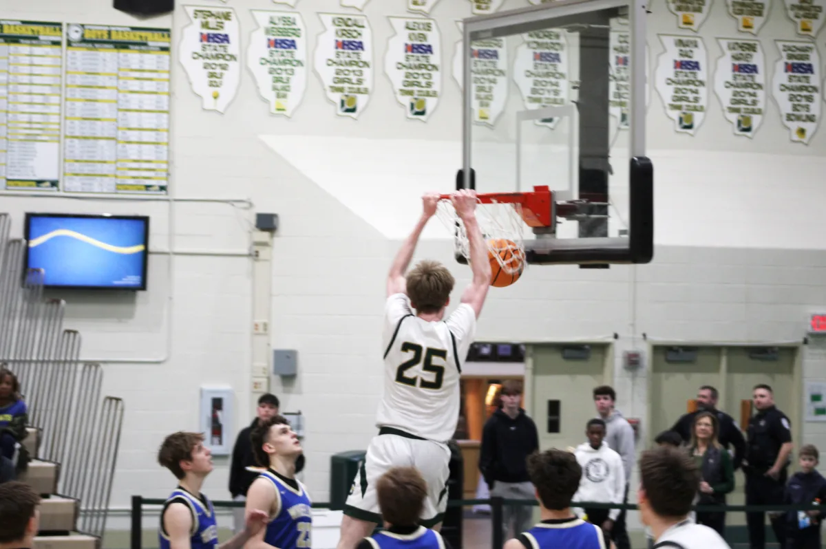  Liam Curtin ’25 slams home a powerful dunk against the Wheeling Wildcats, electrifying the crowd with an impressive finish. The highlight play gave the Patriots a boost, intensifying their momentum on the court.